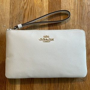 Off white coach wristlet. In great condition. Only used one time.